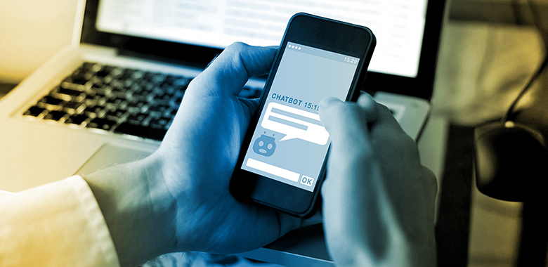 Close up of hands texting on a smartphone with a chatbot on the phone screen.