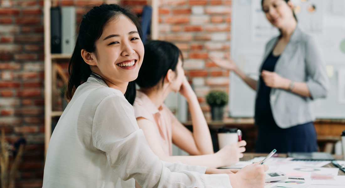 Woman smiling during working meeting.