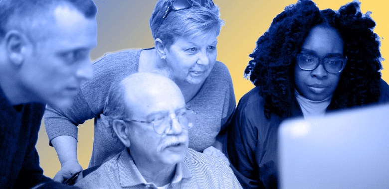 A Brella graphic designer shows his work to a diverse multi-generational group of co-workers.