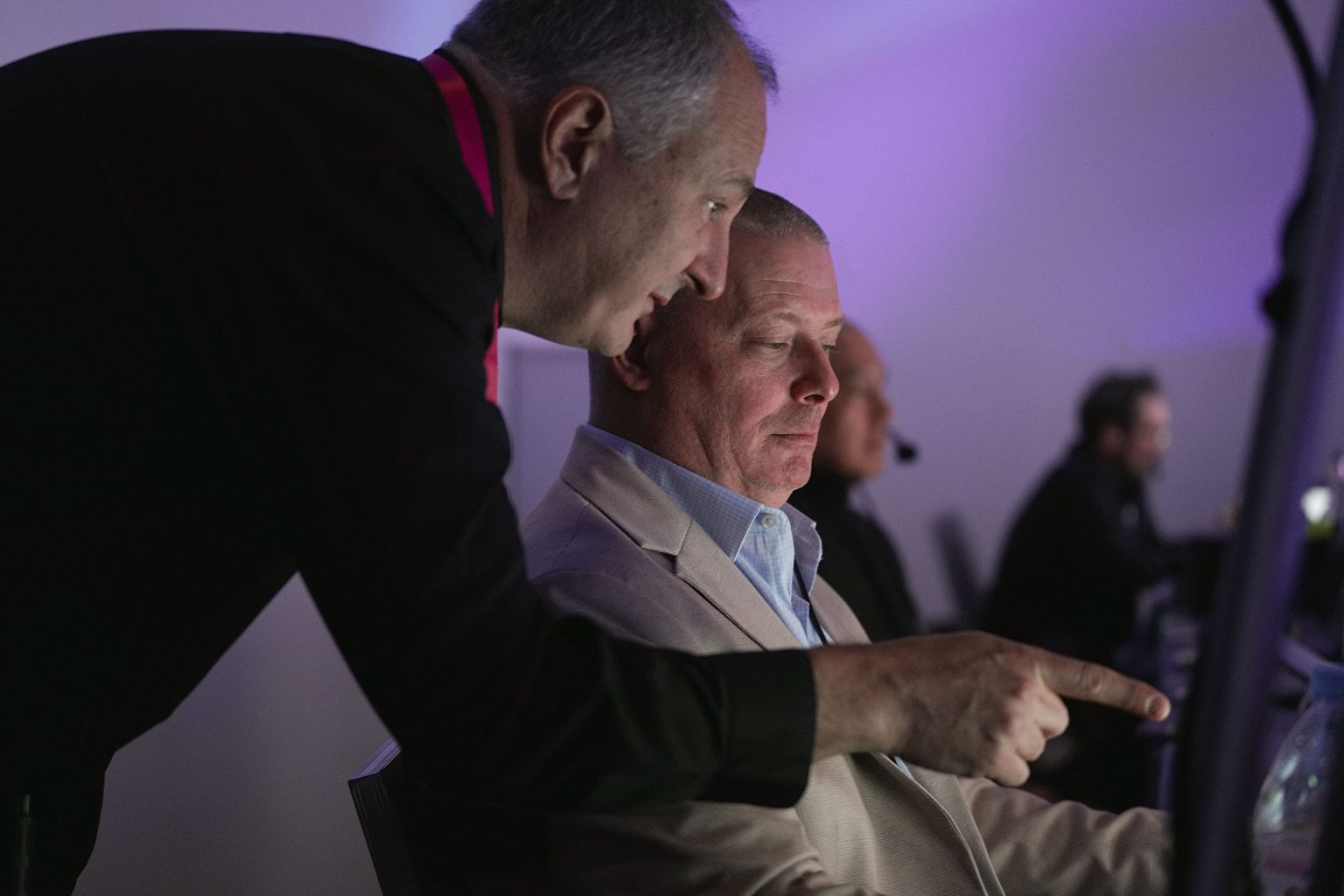 Mark Mallchok, Brella's Sr. Event Strategist, consults with an event management producer during a live corporate event.